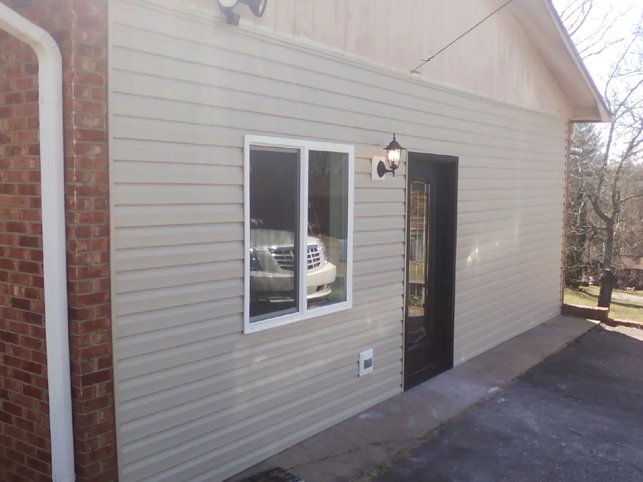 New vinyl siding and entry door on a room addition in Sparta
